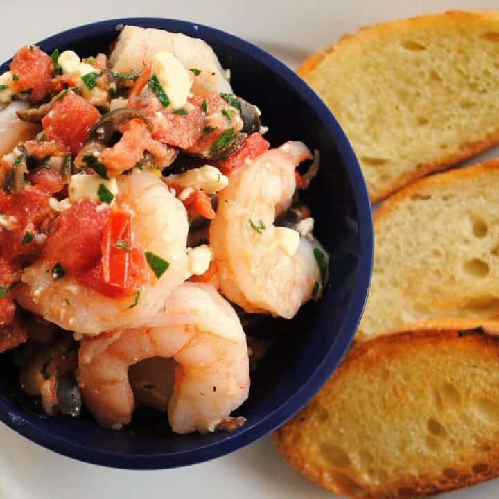 Greek Shrimp Bruschetta - Perfect for a party! Sauteed shrimp with olives, tomato, feta and capers. Serve with crunchy bruschetta. | foxeslovelemons.com