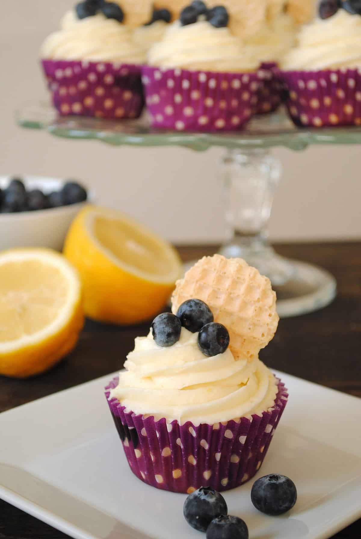 Blueberry Cupcakes with Lemon Cream Cheese Frosting - Lemon-flecked Greek yogurt blueberry cupcakes with lemon cream cheese frosting. | foxeslovelemons.com