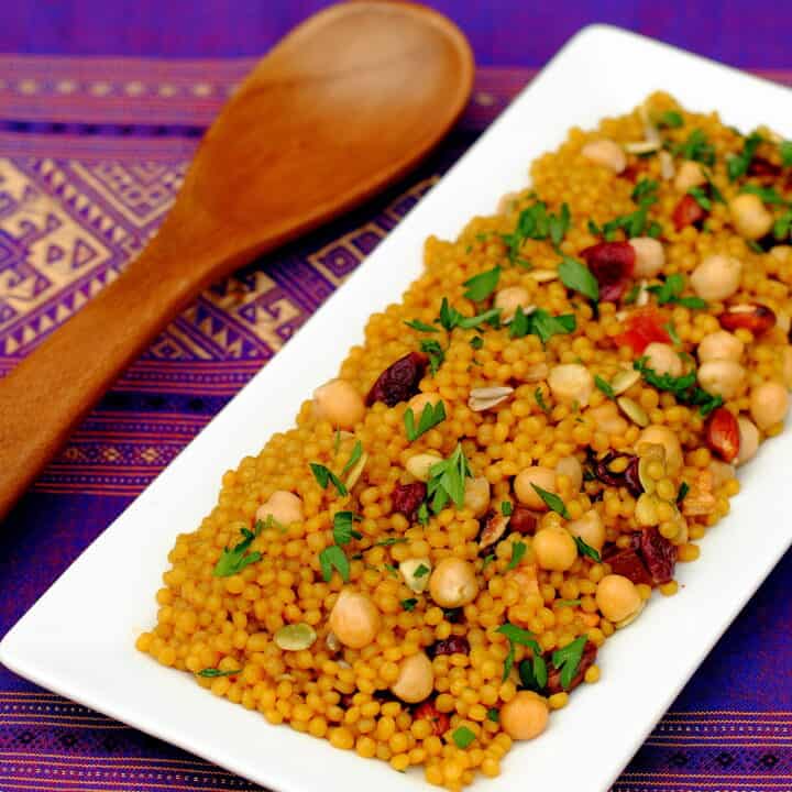 Curried Cranberry Couscous Pilaf – an easy yet elegant side dish of Israeli couscous tossed with chickpeas, dried fruit and nuts. | foxeslovelemons.com