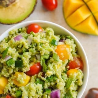 Guacamole Quinoa with Mango - all of the ingredients of guacamole, combined with quinoa and a little mango, for a tasty, healthy side dish! Serve warm or cold. | foxeslovelemons.com