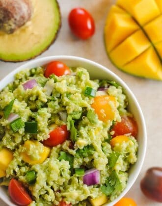 Guacamole Quinoa with Mango - all of the ingredients of guacamole, combined with quinoa and a little mango, for a tasty, healthy side dish! Serve warm or cold. | foxeslovelemons.com