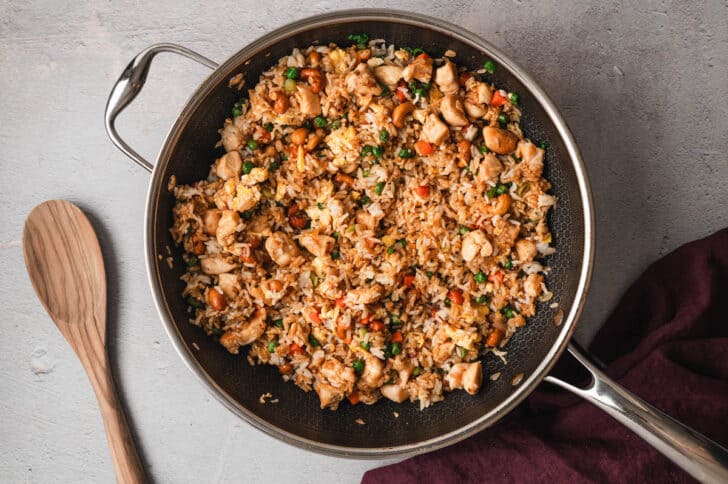 A dark nonstick skillet filled with the best chicken fried rice recipe.