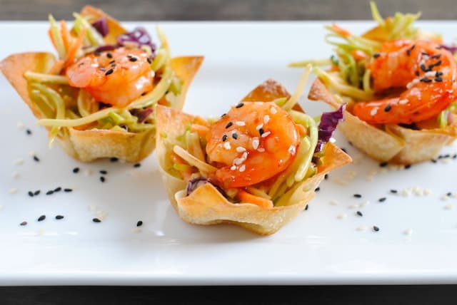 Asian Shrimp Wonton Cups - Crunchy wonton cups filled with broccoli slaw and topped with sweet chili glazed shrimp. Special yet incredibly simple! | foxeslovelemons.com
