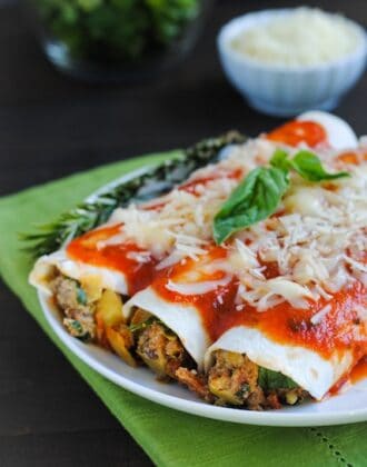Italian Enchiladas - A tasty casserole (with hidden veggies!) the whole family will enjoy! Ground beef, Italian sausage, pepperoni, artichokes, spinach, mushrooms and ricotta cheese rolled up in flour tortillas, topped with marinara and mozzarella. | foxeslovelemons.com