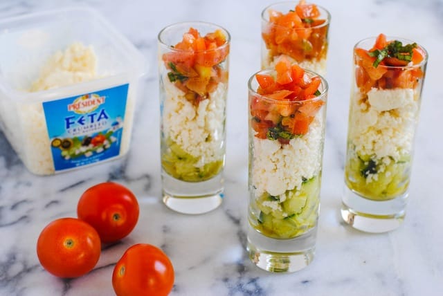 Feta Salad Shooters - layers of crunchy cucumber, tangy feta cheese, and fresh tomato and basil. A perfect, simple party bite for the summer! | foxeslovelemons.com