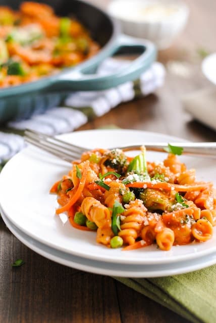 Creamy Veggie Pasta Skillet - A hearty vegetarian meal that comes together in one skillet. Creamy pasta loaded with carrots, broccoli and peas. | foxeslovelemons.com