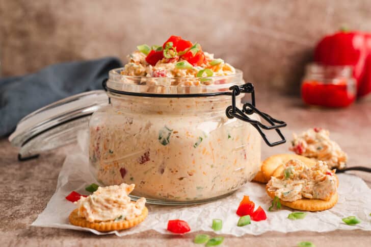 A glass jar filled with a homemade pimento cheese recipe.