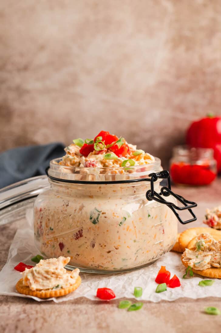A glass jar filled with a pimento cheese dip recipe.