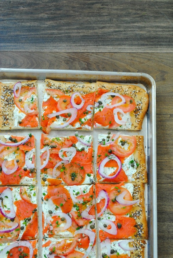 Everything Bagel Pizza with Lox - Pizza crust with homemade everything bagel seasoning, herbed cream cheese, smoked salmon, tomatoes, red onion and capers. Can be cut into small pieces for an elegant party bite! | foxeslovelemons.com