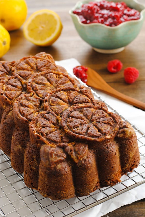 Lemon Pound Cake with Raspberry Compote - A stunning pound cake with a triple shot of lemon flavor, served with a quick raspberry sauce. | foxeslovelemons.com