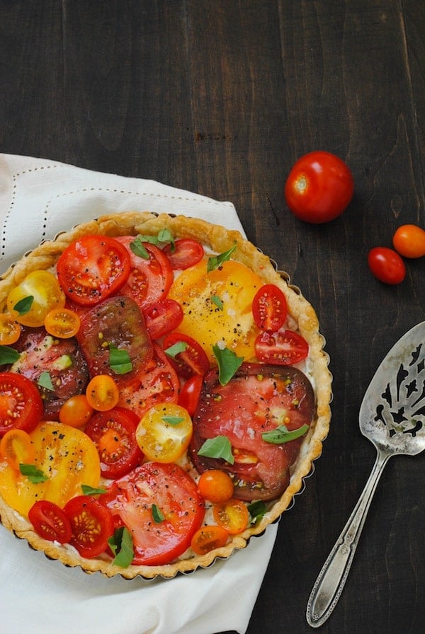 Heirloom Tomato Tart - A beautiful savory tart layered with a ricotta, blue cheese and fresh tomatoes. | foxeslovelemons.com
