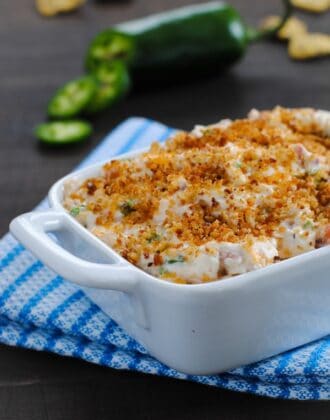 Lightened-Up Jalapeño Popper Dip - Perfect for tailgating and game-watching parties! All the flavors of a jalapeño popper, lightened-up in a dip made with Greek yogurt, turkey bacon, Cheddar cheese and a crunchy breadcrumb topping. | foxeslovelemons.com