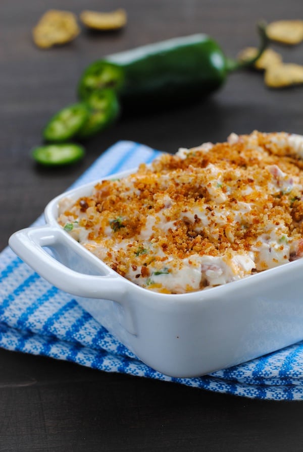 Lightened-Up Jalapeño Popper Dip - Perfect for tailgating and game-watching parties! All the flavors of a jalapeño popper, lightened-up in a dip made with Greek yogurt, turkey bacon, Cheddar cheese and a crunchy breadcrumb topping. | foxeslovelemons.com