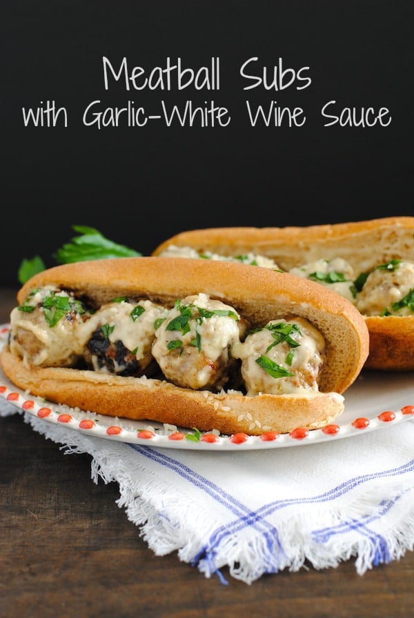 Meatball Subs with Garlic-White Wine Sauce - Perfect for tailgating and game-watching parties! Can be kept warm in a slow cooker until ready to serve. | foxeslovelemons.com