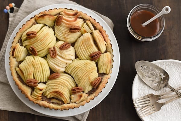 Apple & Pecan Tart with Bourbon Caramel Sauce - A flaky tart crust layered with homemade maple-pecan butter and apples, then drizzled with decadent bourbon caramel sauce! | foxeslovelemons.con