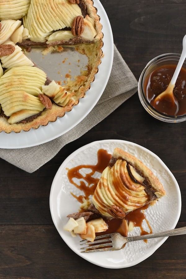 Apple & Pecan Tart with Bourbon Caramel Sauce - A flaky tart crust layered with homemade maple-pecan butter and apples, then drizzled with decadent bourbon caramel sauce! | foxeslovelemons.con
