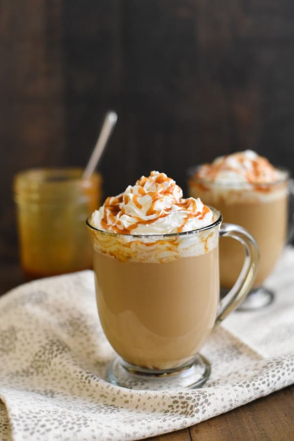 Sweet latte drink topped with white cream and dessert sauce.