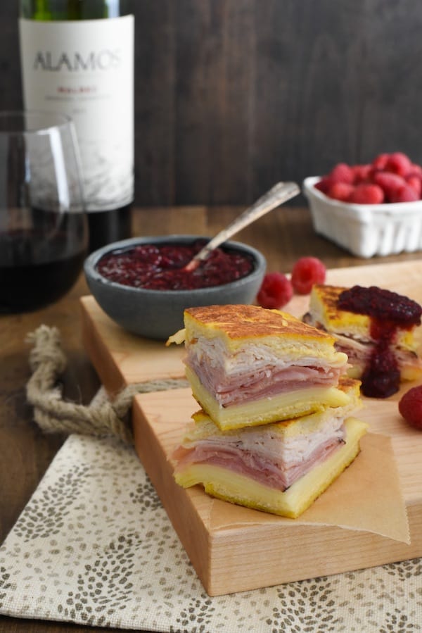 Monte Cristo Party Bites with Raspberry-Malbec Jam - The classic diner sandwich dressed up as a fancy appetizer! Griddled sandwiches filled with ham, turkey and fontina cheese, with a side of homemade jam for dipping! | foxeslovelemons.com