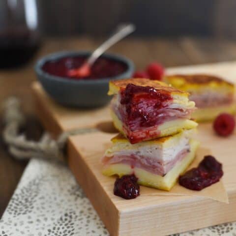 Monte Cristo Party Bites with Raspberry-Malbec Jam - The classic diner sandwich dressed up as a fancy appetizer! Griddled sandwiches filled with ham, turkey and fontina cheese, with a side of homemade jam for dipping! | foxeslovelemons.com