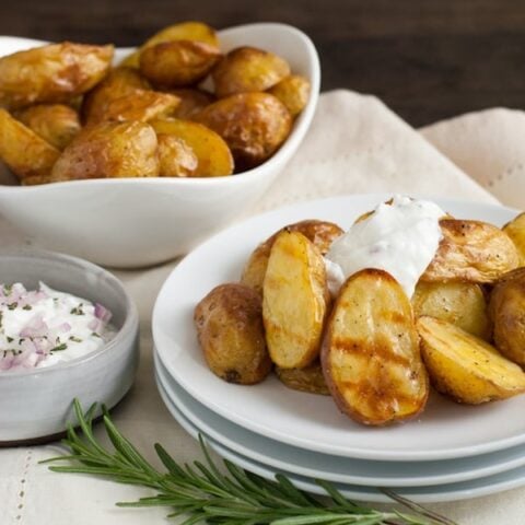 Super Crispy Roasted Potatoes with Shallot-Rosemary Yogurt - A simple technique for roasting potatoes that makes them SUPER crispy and delicious. Plus, a savory dipping sauce! | foxeslovelemons.com