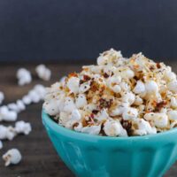 Pizza Popcorn - Start with a big bowl of popped popcorn, then whip up a quick pizza-flavored olive oil that includes sun-dried tomatoes, Parmesan cheese, and lots of Italian herbs. | foxeslovelemons.com