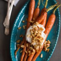 Roasted Glazed Carrots with Greek Yogurt & Buttered Pine Nuts - Carrots don't have to be a lowly side dish. These will be the highlight of your dinner plate, guaranteed! | foxeslovelemons.com