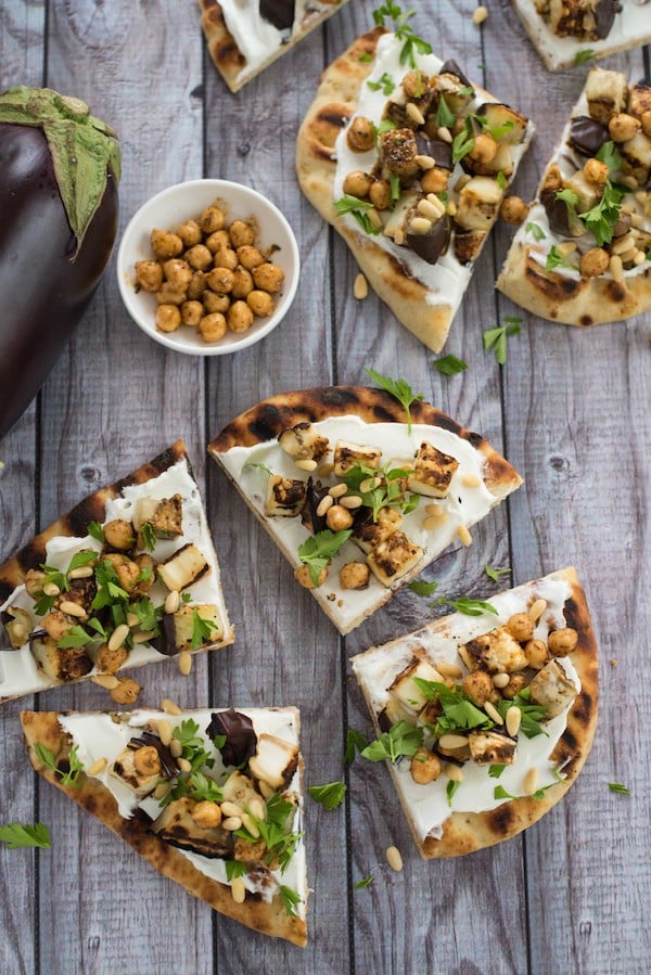 Grilled Eggplant Flatbread - A lovely vegetarian meal or party bite that comes together in a flash. Grilled naan bread is spread with creamy Greek yogurt and topped with grilled eggplant, spiced chickpeas and pine nuts. | foxeslovelemons.com