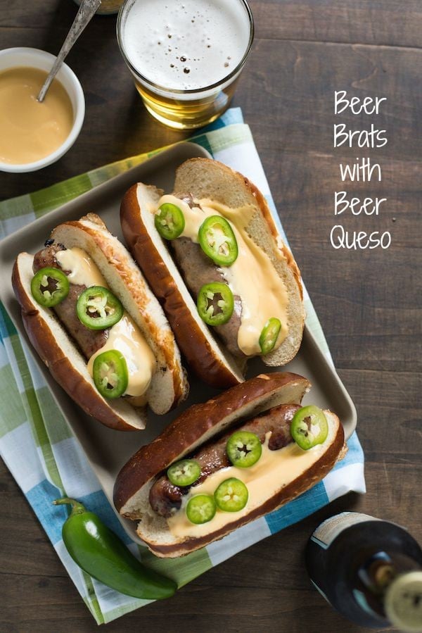 Beer Brats with Beer Queso - For the beer and grilling lovers in your life! Beer-flavored bratwurst topped with a sharp cheddar-beer queso. Serve with beer! | foxeslovelemons.com