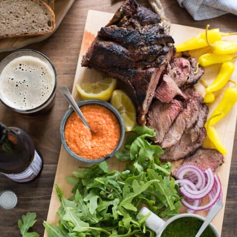 Grilled Lamb Sandwich Platter - Change up your grilling game with a boneless leg of lamb! It cooks in the same amount of time as a thick steak, and has a rich delicious flavor. Pile sandwich fixings, zesty feta spread, chimichurri and rye bread onto a big board, and dinner is served! | foxeslovelemons.com
