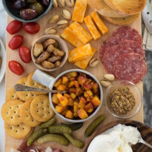 Summer Cheese & Charcuterie Board with Spicy Peach Chutney - Use a little help from your grocery store, pile everything onto a big cutting board and serve dinner "platter" style. Fresh summer peaches make a super-easy Spicy Peach Chutney. | foxeslovelemons.com