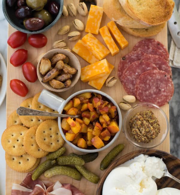 Summer Cheese & Charcuterie Board with Spicy Peach Chutney - Use a little help from your grocery store, pile everything onto a big cutting board and serve dinner "platter" style. Fresh summer peaches make a super-easy Spicy Peach Chutney. | foxeslovelemons.com