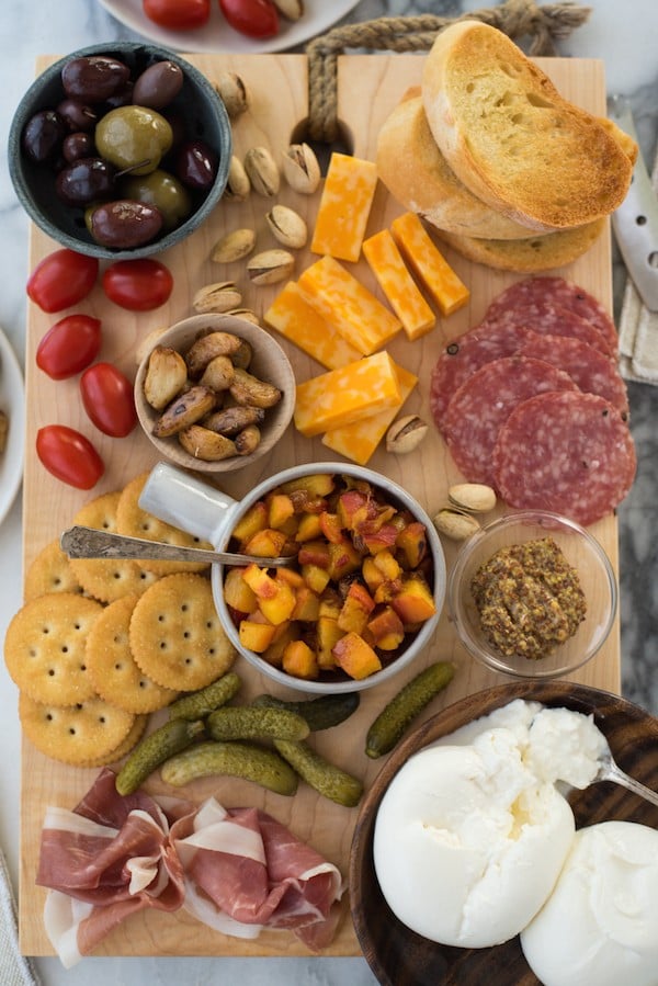 Summer Cheese & Charcuterie Board with Spicy Peach Chutney - Use a little help from your grocery store, pile everything onto a big cutting board and serve dinner "platter" style. Fresh summer peaches make a super-easy Spicy Peach Chutney. | foxeslovelemons.com