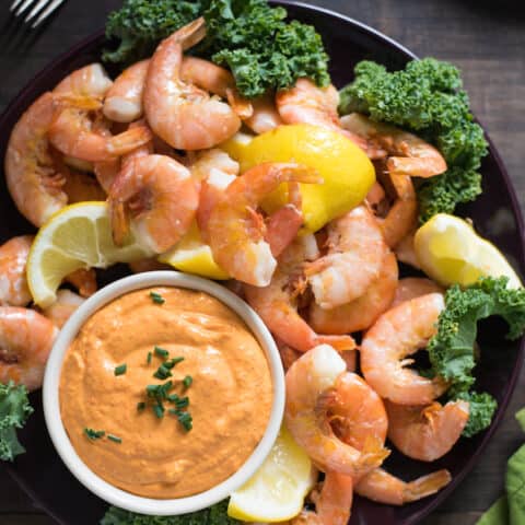 Roasted Lemon Shrimp Cocktail with Piquillo Pepper Dip - A Spanish-inspired twist on classic peel-and-eat shrimp cocktail. Serve as an appetizer at your next party and watch it disappear! | foxeslovelemons.com