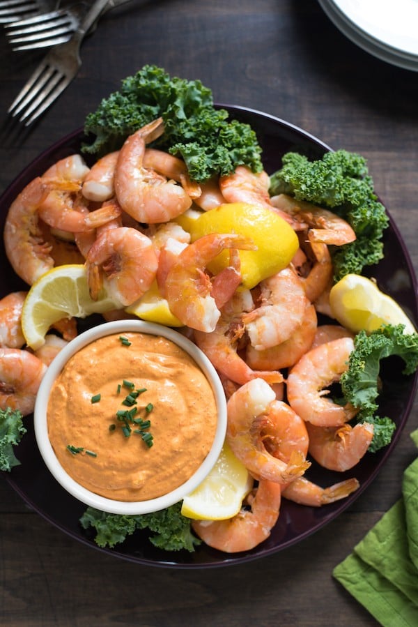 Roasted Lemon Shrimp Cocktail with Piquillo Pepper Dip - A Spanish-inspired twist on classic peel-and-eat shrimp cocktail. Serve as an appetizer at your next party and watch it disappear! | foxeslovelemons.com