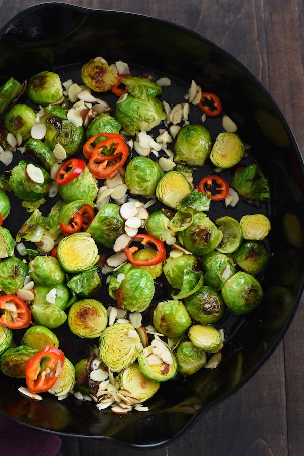 Lemon & Maple Glazed Roasted Brussels Sprouts - Roasted brussels sprouts with a tangy-sweet glaze, almonds and chile pepper. | foxeslovelemons.com