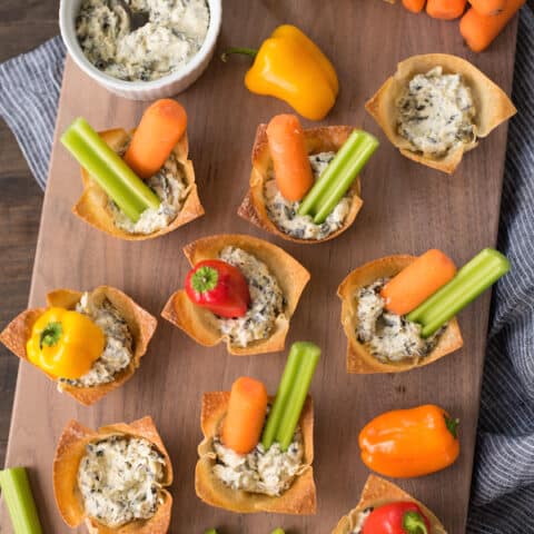 Veggie & Dip Wonton Cups - A veggie and dip tray, in adorable personal-sized portions! Edible wonton wrapper cups are filled with creamy dip and topped with fresh veggies. | foxeslovelemons.com