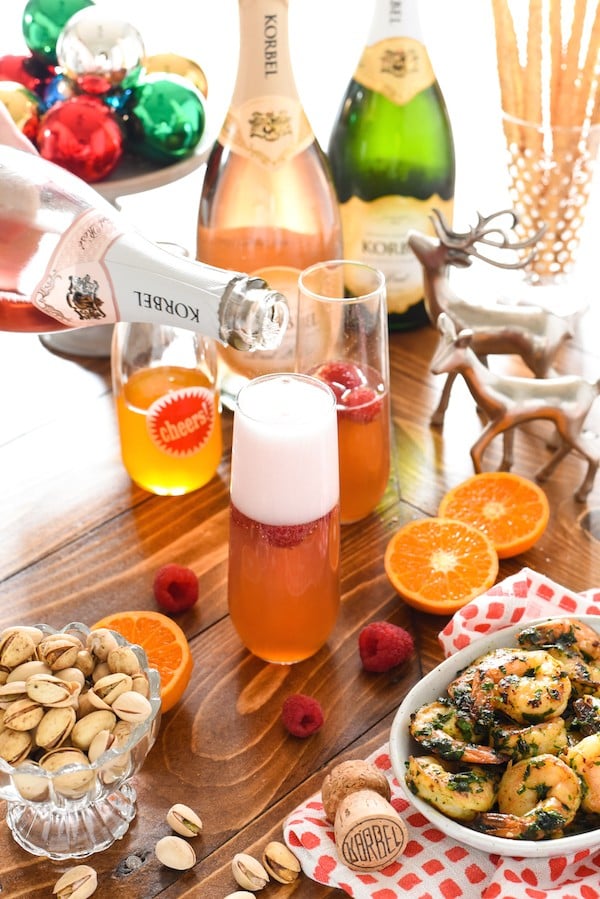 Clementine & Raspberry Rosé Fizz - A sweet and fun bubbly cocktail perfect for brunch! | foxeslovelemons.com