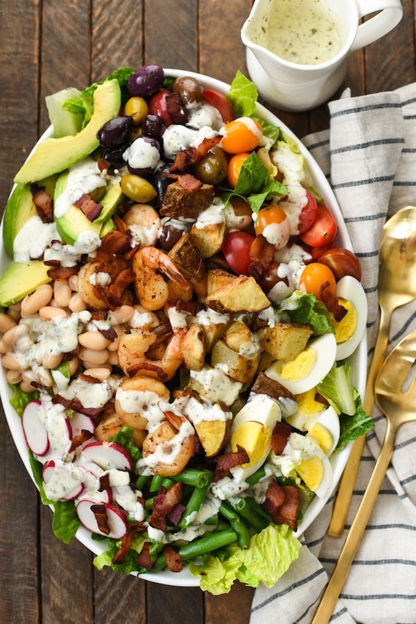 Mega Chopped Salad with Shrimp & Roasted Potatoes - Clean out your fridge and pantry for this salad that is a meal itself. Drizzle with homemade Pesto Ranch Dressing (recipe included). | foxeslovelemons.com