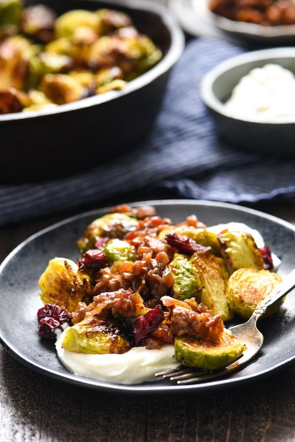 Roasted Brussels Sprouts with Greek Yogurt & Bacon Jam - A restaurant-quality side dish that you can easily serve at home. The whole family will eat their vegetables with this one! | foxeslovelemons.com