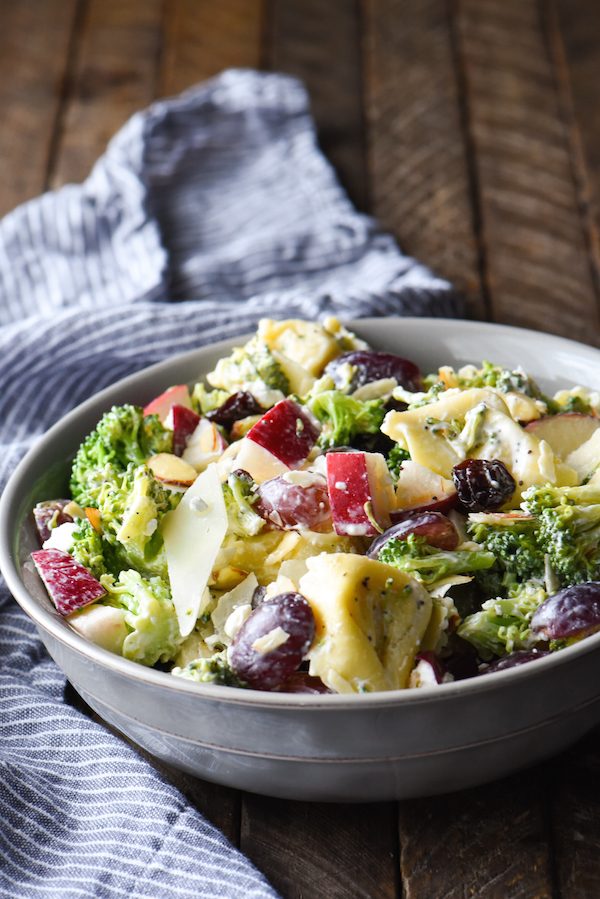 Chopped Broccoli Salad with Cheese Tortellini - A party favorite! Everyone in the crowd will wants seconds of this tortellini salad full of broccoli, cheese, fruit and nuts. | foxeslovelemons.com