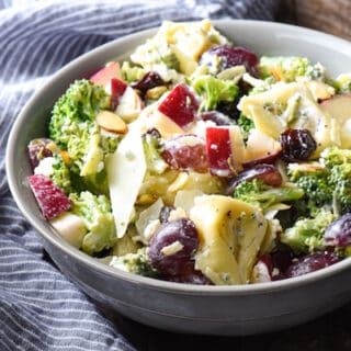 Chopped Broccoli Salad with Cheese Tortellini - A party favorite! Everyone in the crowd will wants seconds of this tortellini salad full of broccoli, cheese, fruit and nuts. | foxeslovelemons.com