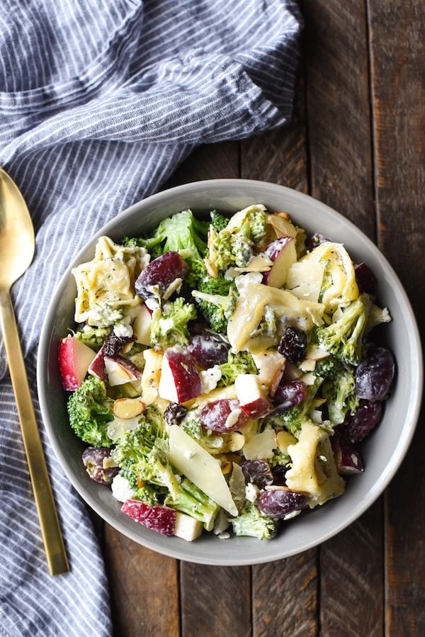 Chopped Broccoli Salad with Cheese Tortellini - A party favorite! Everyone in the crowd will wants seconds of this tortellini salad full of broccoli, cheese, fruit and nuts. | foxeslovelemons.com