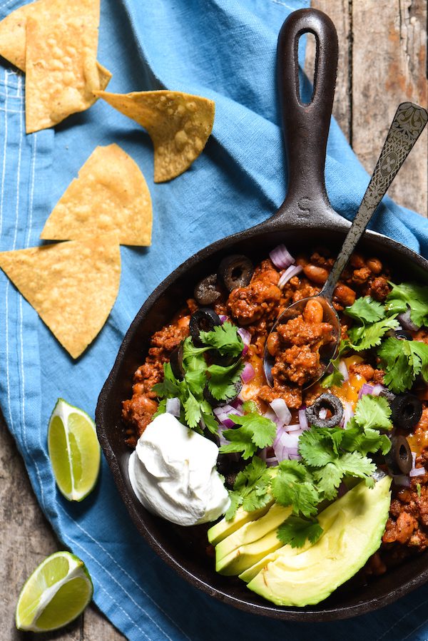 Meaty Enchilada Chili Dip - This dip will keep your party guests coming back with another chip again and again! | foxeslovelemons.com
