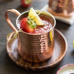 Double Strawberry Moscow Mules - An even more summery twist on a summer cocktail! Jazz up the beloved Moscow Mule with fresh strawberries and strawberry preserves. | foxeslovelemons.com