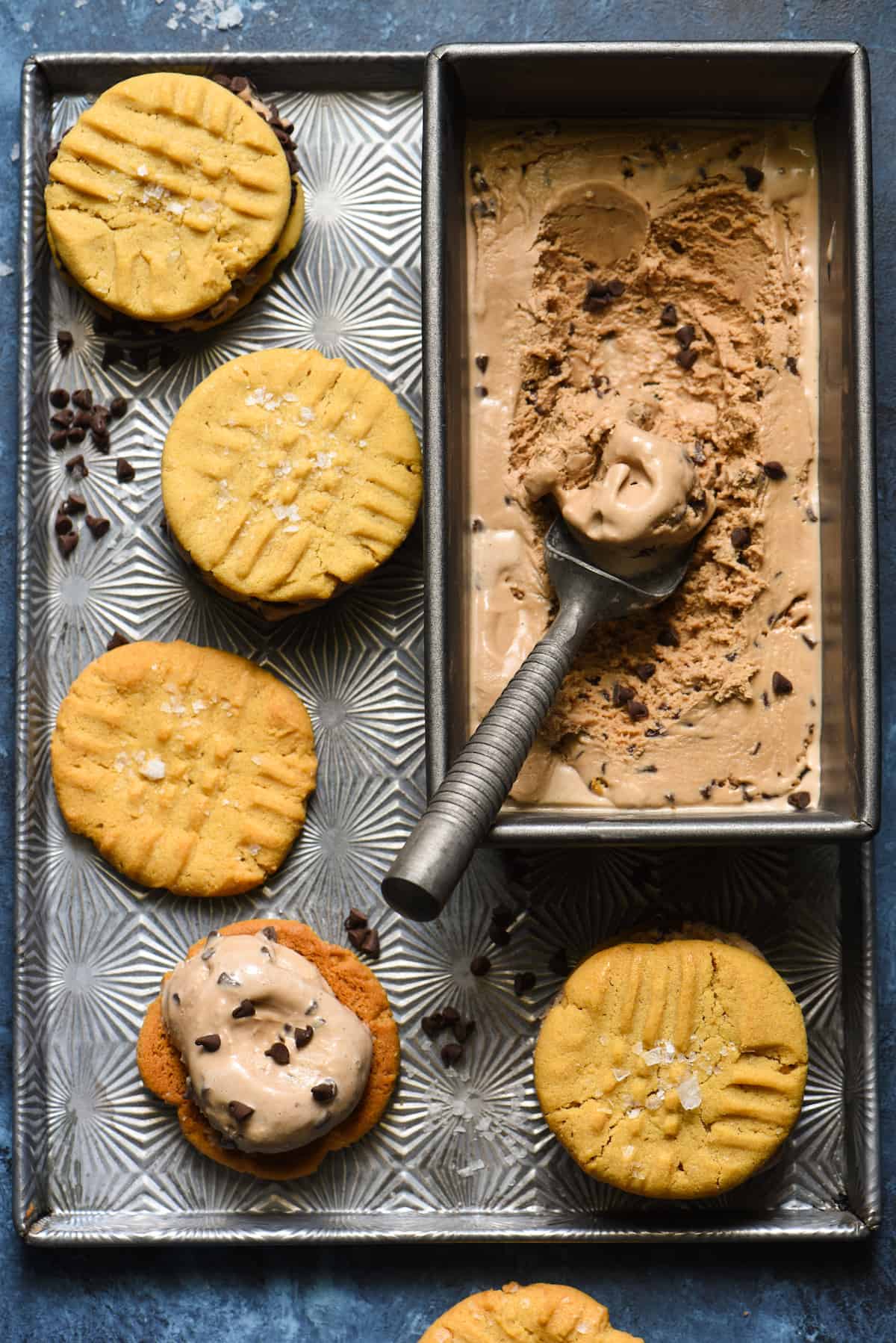 Salted Peanut Butter and Chocolate-Chocolate Chip Ice Cream Sandwiches - Make these for the chocolate and peanut butter lover in your life! Peanut butter cookies are finished with flaky sea salt and then sandwiched with triple-chocolate ice cream. | foxeslovelemons.com