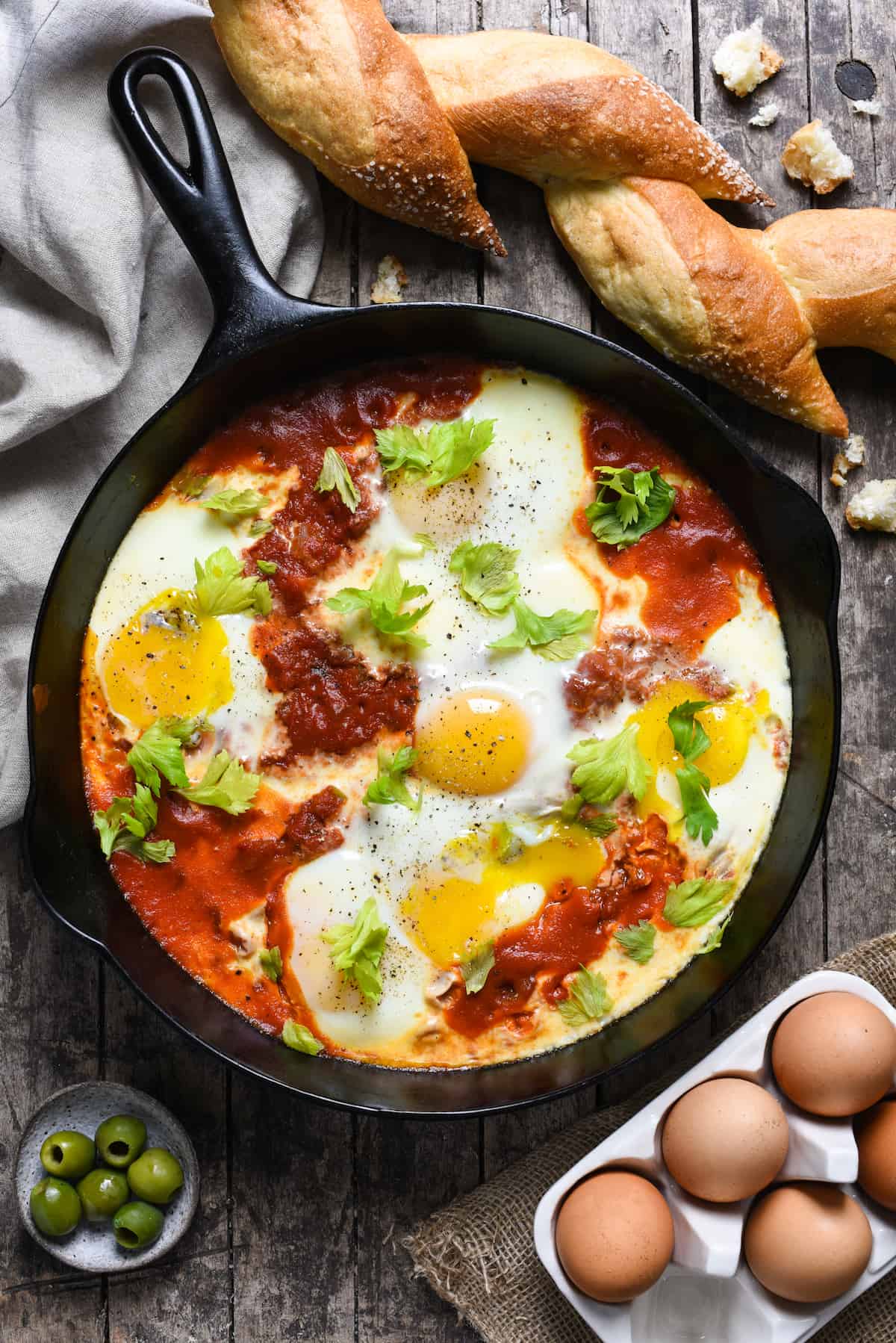 Bloody Mary Shakshuka - Horseradish-infused tomatoes topped with soft eggs. Serve with crusty bread for a quick, easy and very affordable meal! | foxeslovelemons.com