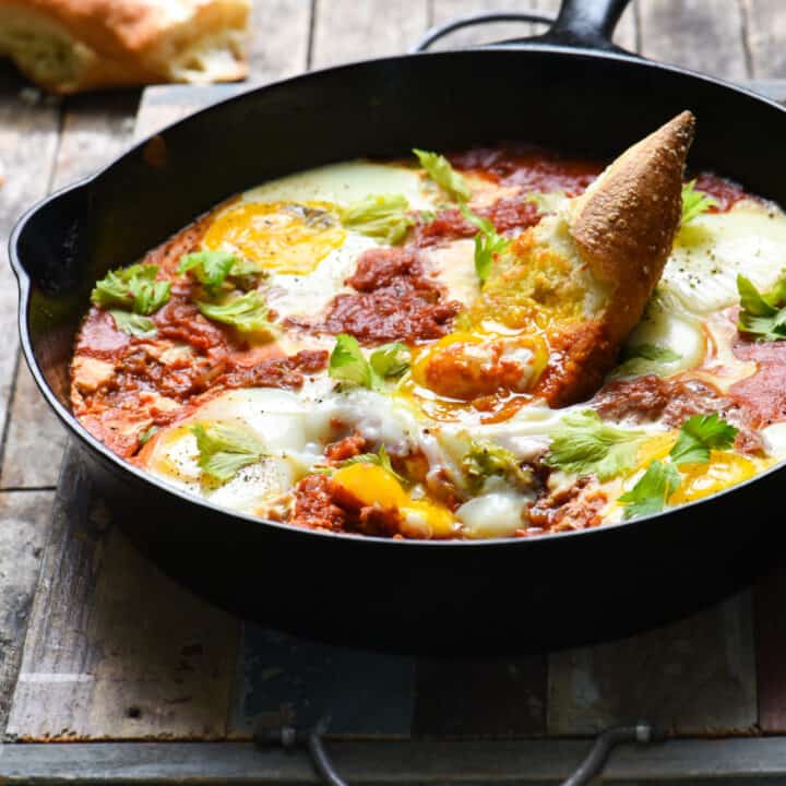 Bloody Mary Shakshuka - Horseradish-infused tomatoes topped with soft eggs. Serve with crusty bread for a quick, easy and very affordable meal! | foxeslovelemons.com