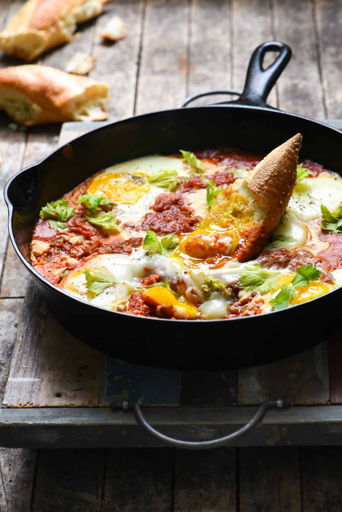 Bloody Mary Shakshuka - Horseradish-infused tomatoes topped with soft eggs. Serve with crusty bread for a quick, easy and very affordable meal! | foxeslovelemons.com