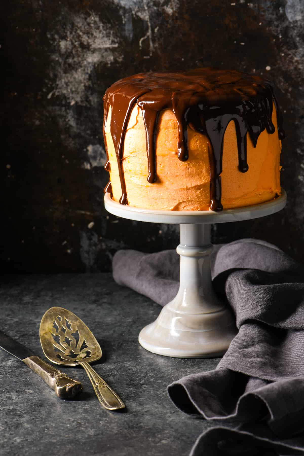 Orange Cream Cake with Chocolate Ganache - Spook your family and friends with this decadent five-layer drip cake. | foxeslovelemons.com
