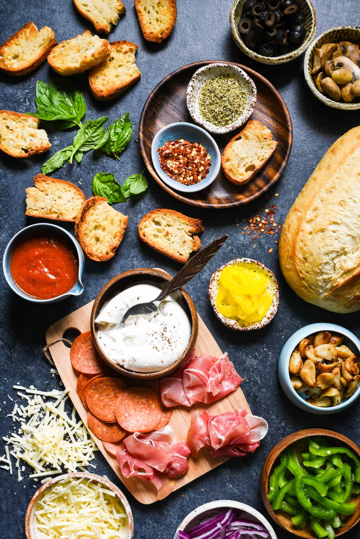 Pizza Crostini Bar - Put out some toasted bread and a big spread of pizza toppings, and let everybody make their own appetizer. So fun for parties! | foxeslovelemons.com